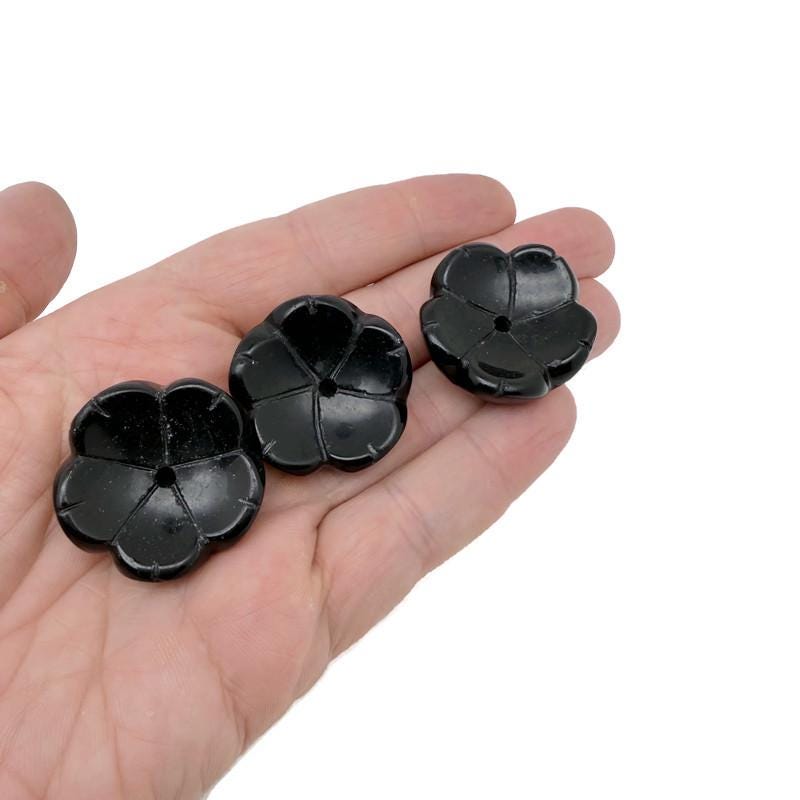 Obsidian crystal flower-shaped incense holder from GemstoneGO, designed for cleansing and relaxation with carved flower details.