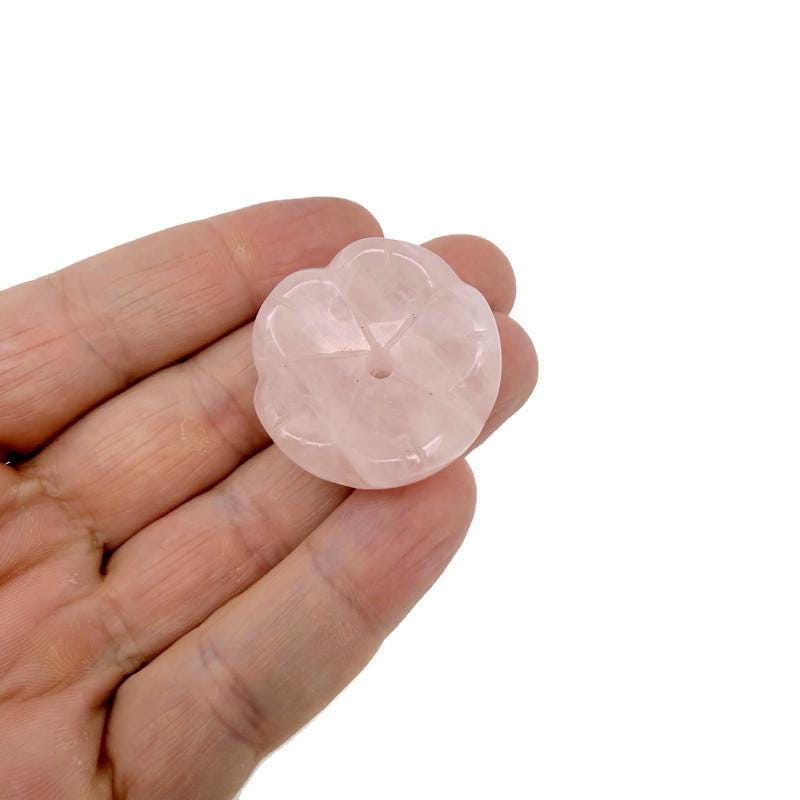 Rose quartz crystal flower-shaped incense holder from GemstoneGO, designed for cleansing and relaxation, with carved floral details.