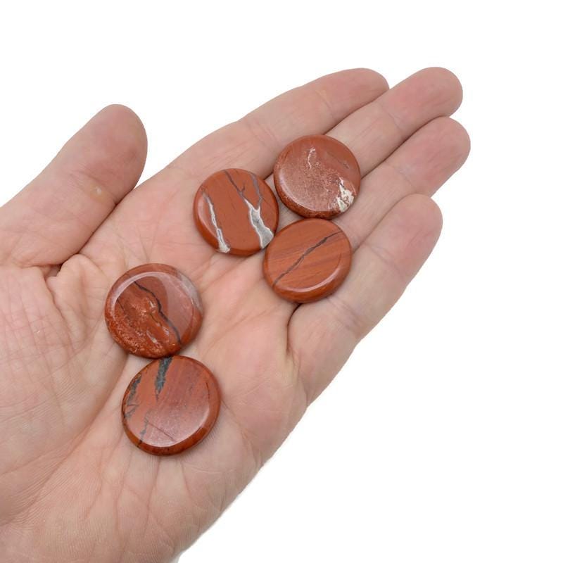 Round red jasper flat gemstone slab, 25mm, showing smooth polished surface and vibrant red color from GemstoneGO.