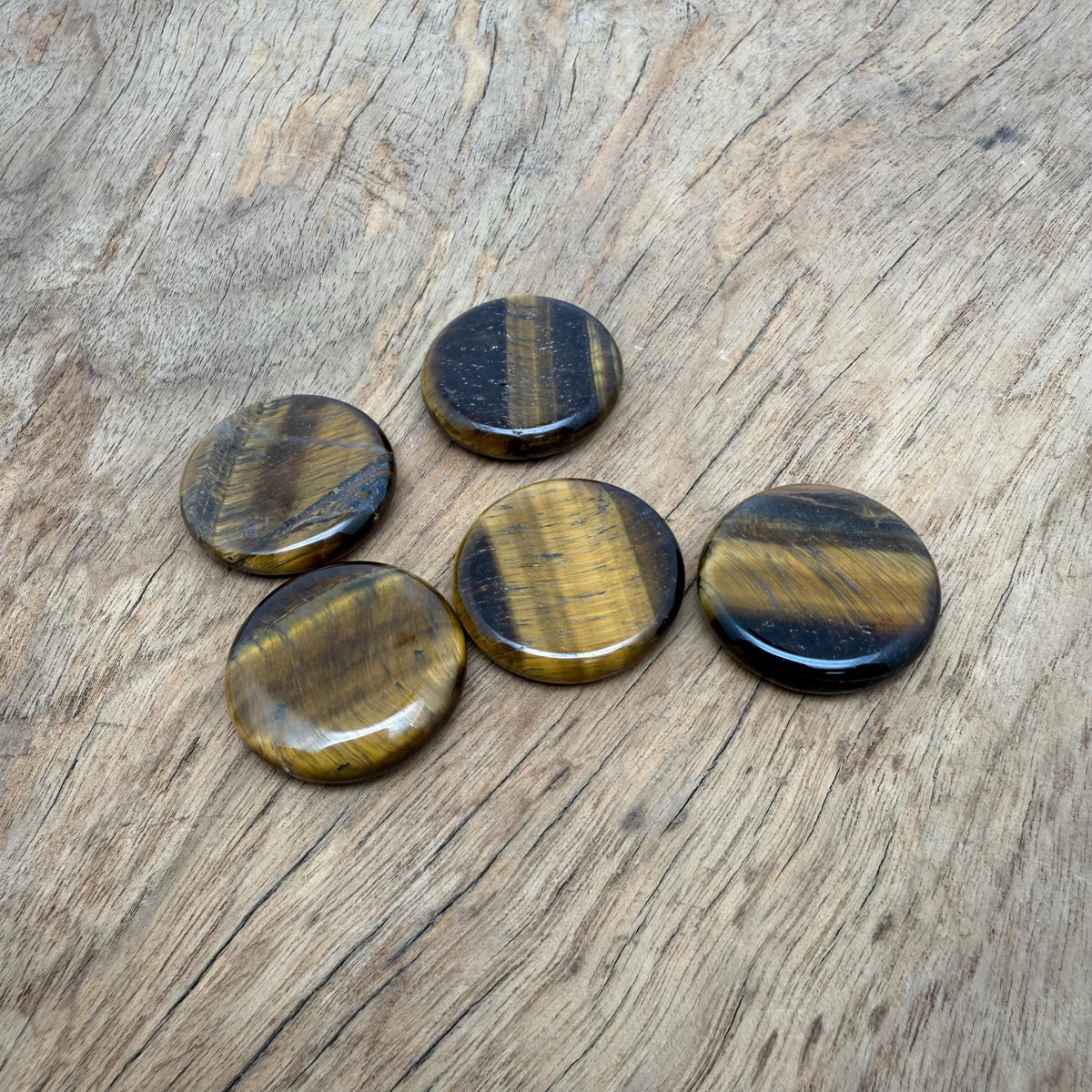 Round Tiger Eye flat gemstone slab, 25mm crystal from GemstoneGO, showcasing rich golden-brown chatoyancy and smooth polished surface.