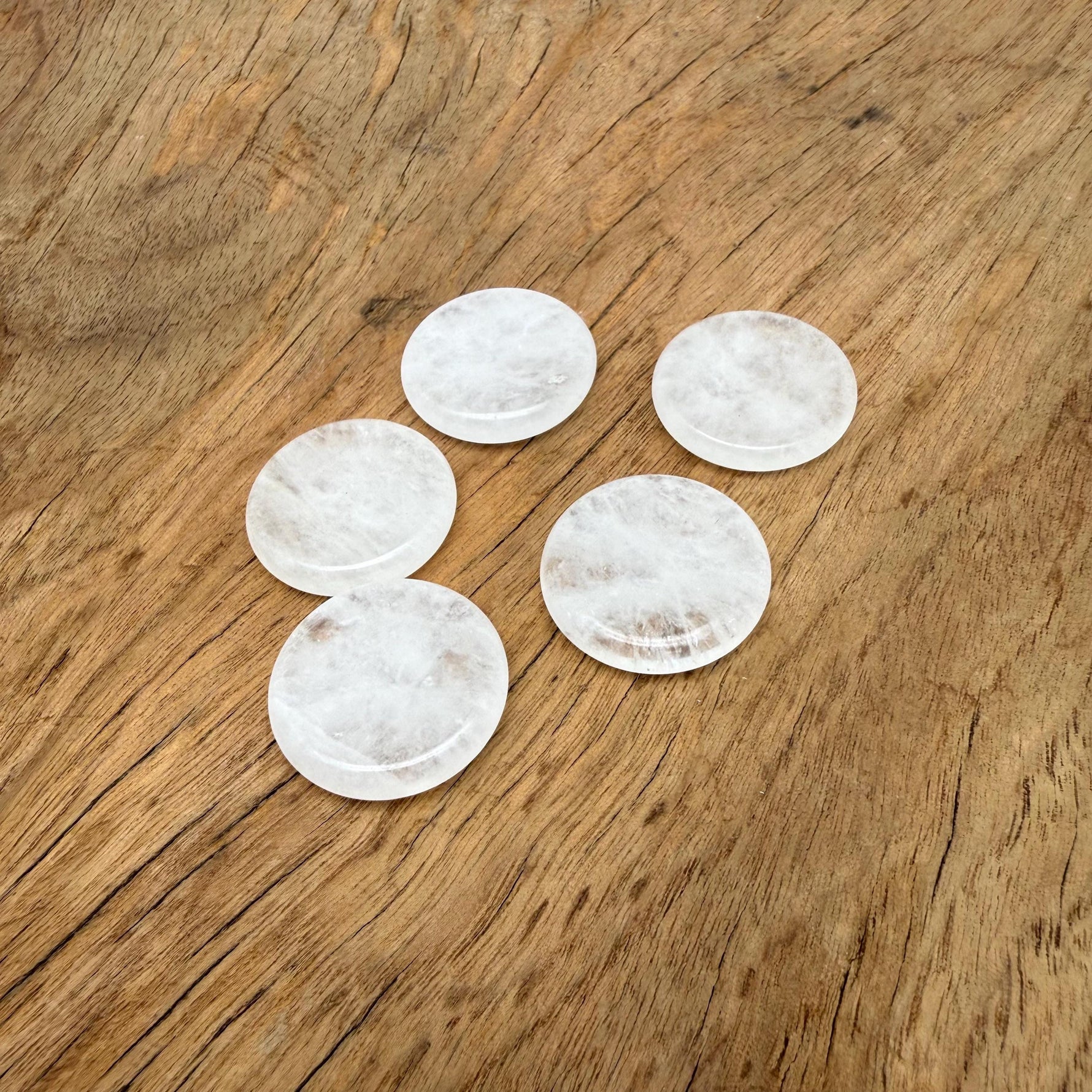 Round clear quartz flat gemstone slab, 25mm, from GemstoneGO, showing the smooth, transparent crystal surface with subtle natural markings.