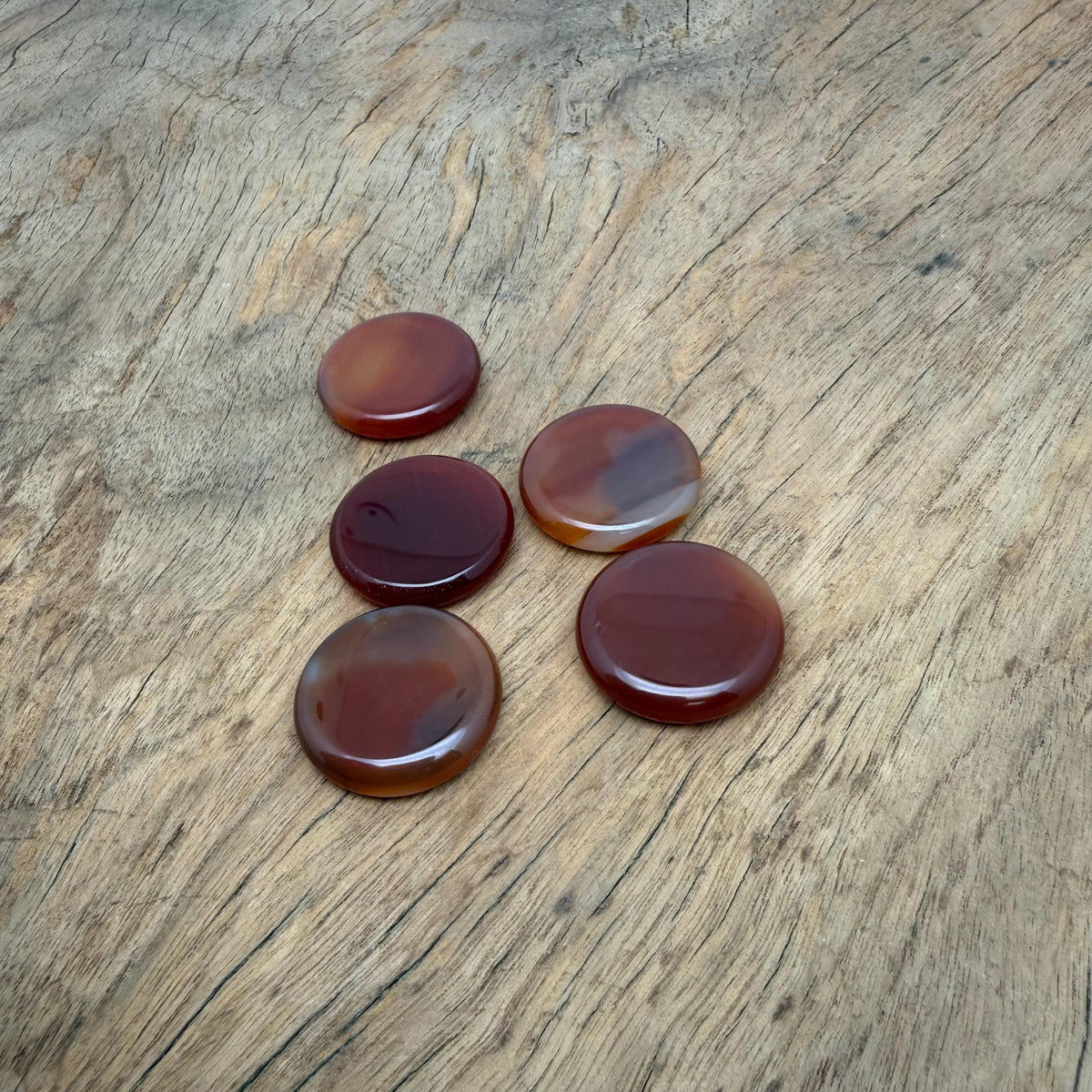 Round Carnelian flat gemstone slab, 25mm crystal from GemstoneGO, showcasing vibrant orange-red color and smooth polished surface.