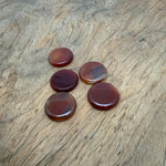 Round Carnelian flat gemstone slab, 25mm crystal from GemstoneGO, showcasing vibrant orange-red color and smooth polished surface.