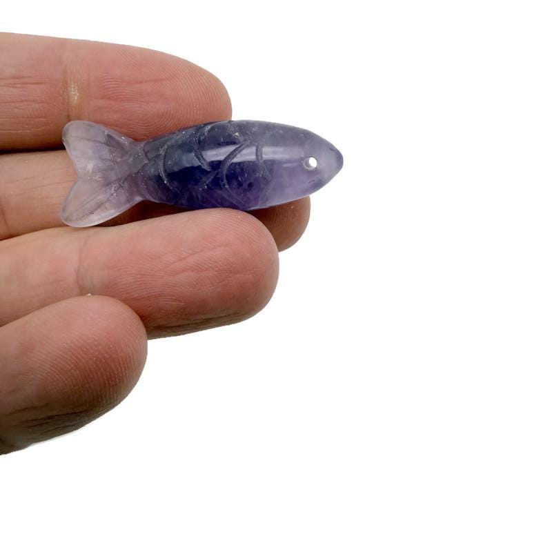 Amethyst fish gemstone pendant from GemstoneGO, featuring a purple fish-shaped charm, ideal as a lucky fishing or gift pendant.