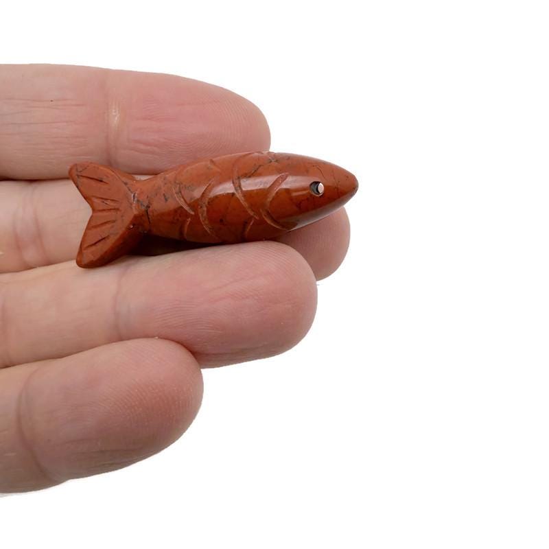 Red Jasper fish gemstone pendant with a polished fish shape, featuring vibrant red color and intricate details, perfect as a lucky fishing charm.