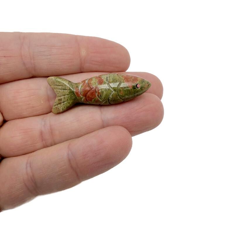 Unakite fish-shaped gemstone pendant from GemstoneGO, featuring vibrant green and pink hues, perfect as a lucky fishing charm.