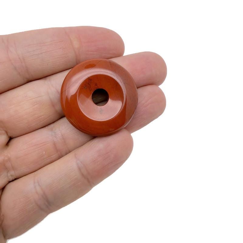 Colorful 30mm crystal donut shaped Pi stone gift from GemstoneGO, featuring a mixed gemstone design on a clear background.