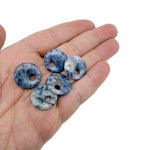 Sodalite crystal donut pendant, 20mm Pi stone from GemstoneGO, showing vibrant blue and white natural stone with polished surface.
