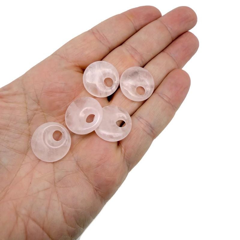 Pink rose quartz crystal donut pendant, 20mm Pi stone from GemstoneGO with a polished, smooth surface.