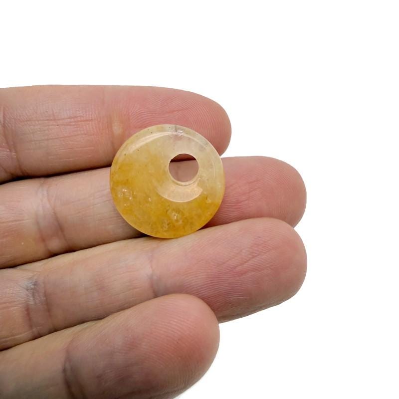 Yellow jade crystal donut pendant with a 20mm Pi stone, showcasing a polished, vibrant yellow gemstone from GemstoneGO.