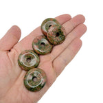Unakite crystal donut pendant from GemstoneGO, 30mm Pi stone with vibrant green and pink mineral patterns.
