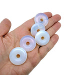 Opalite crystal donut pendant from GemstoneGO, 30mm Pi stone with smooth, rounded design and vibrant iridescent glow.