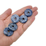 Sodalite crystal donut pendant, 30mm Pi stone from GemstoneGO, featuring vibrant blue and white banded patterns on a polished surface.