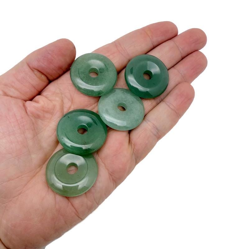 A 30mm Aventurine crystal donut pendant with natural green hues and unique stone patterns, crafted by GemstoneGO.