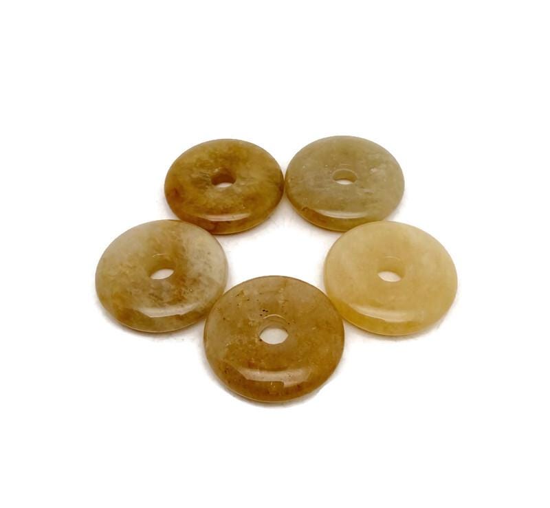 Yellow jade crystal donut pendant from GemstoneGO, 30mm Pi stone with smooth, polished surface and vibrant yellow color.