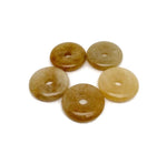 Yellow jade crystal donut pendant from GemstoneGO, 30mm Pi stone with smooth, polished surface and vibrant yellow color.