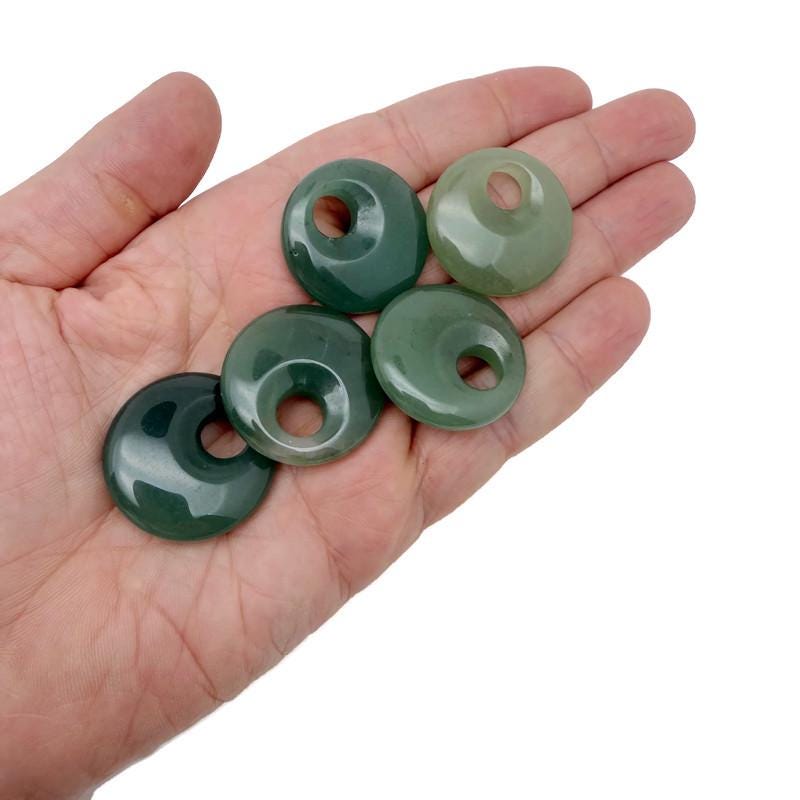 A 30mm aventurine crystal donut pendant from GemstoneGO, showcasing a polished green gemstone with natural patterns.