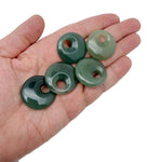 A 30mm aventurine crystal donut pendant from GemstoneGO, showcasing a polished green gemstone with natural patterns.