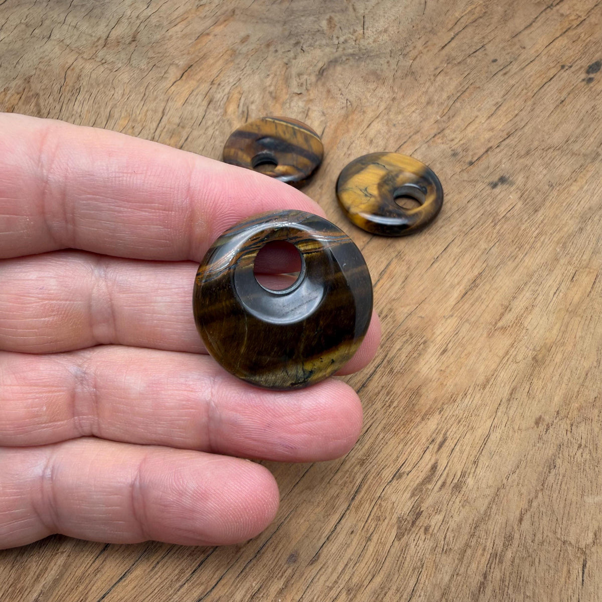 Tiger Eye crystal donut pendant, 30mm Pi stone from GemstoneGO featuring rich golden-brown hues and smooth polished surface.