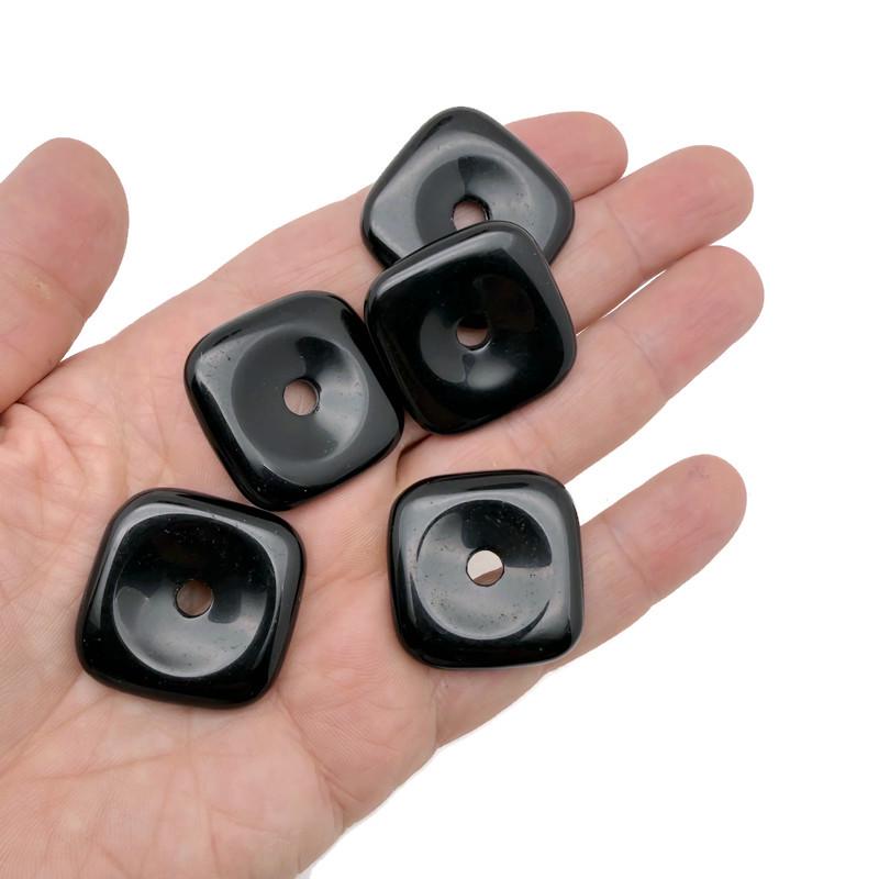 Square obsidian crystal donut from GemstoneGO, featuring a 30mm polished black stone with natural striations and a central hole.