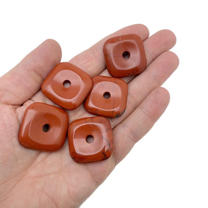 Red Jasper square crystal donut pendant, 30mm Pi stone by GemstoneGO, shows vibrant red color and polished surface.