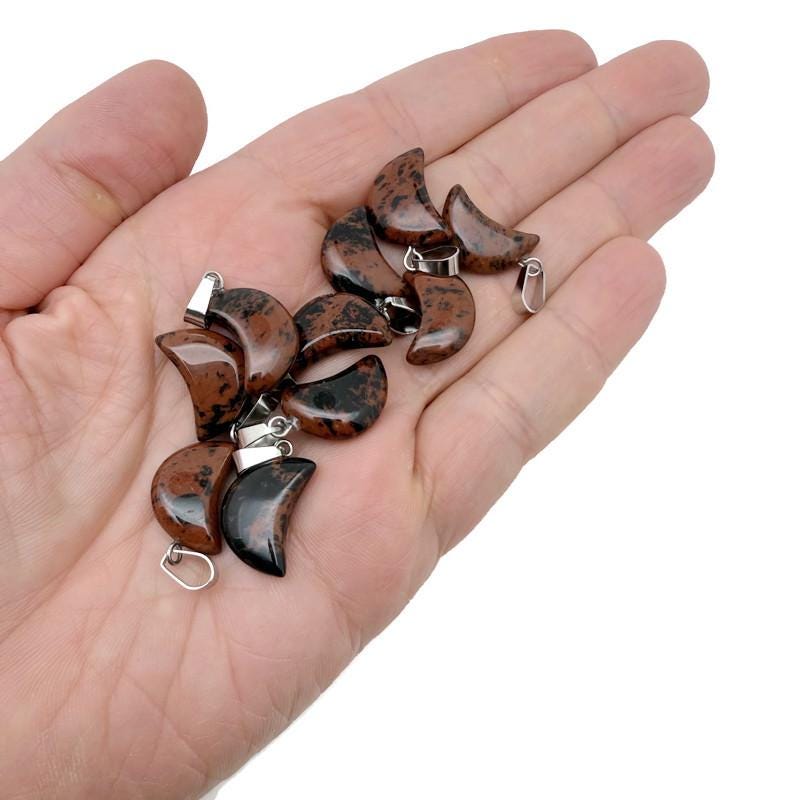 Mahogany Obsidian moon-shaped crystal pendant from GemstoneGO, ideal for jewelry making and crafted with polished gemstone.
