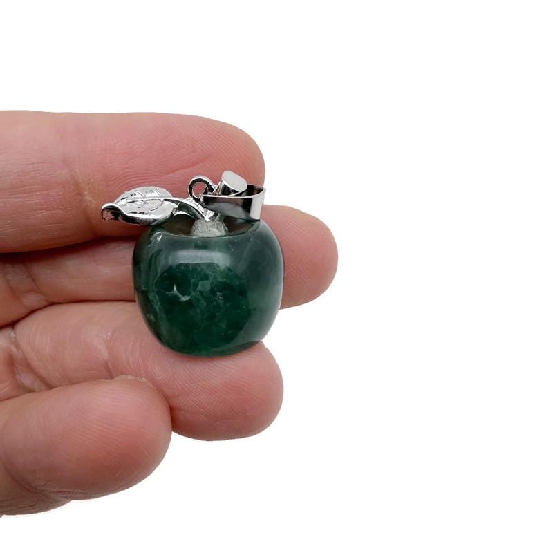 Mini fluorite apple crystal pendant by GemstoneGO, featuring vibrant green and purple hues in a polished gemstone pendant.