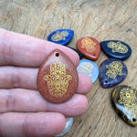 Engraved Hamsa Hand crystal pendant with drilled hole, symbolizing protection, luck, and spiritual energy by GemstoneGO.