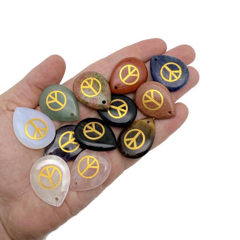 Crystal charm with engraved peace symbol, drilled for jewelry, symbolizing calm, harmony, and positive energy by GemstoneGO.