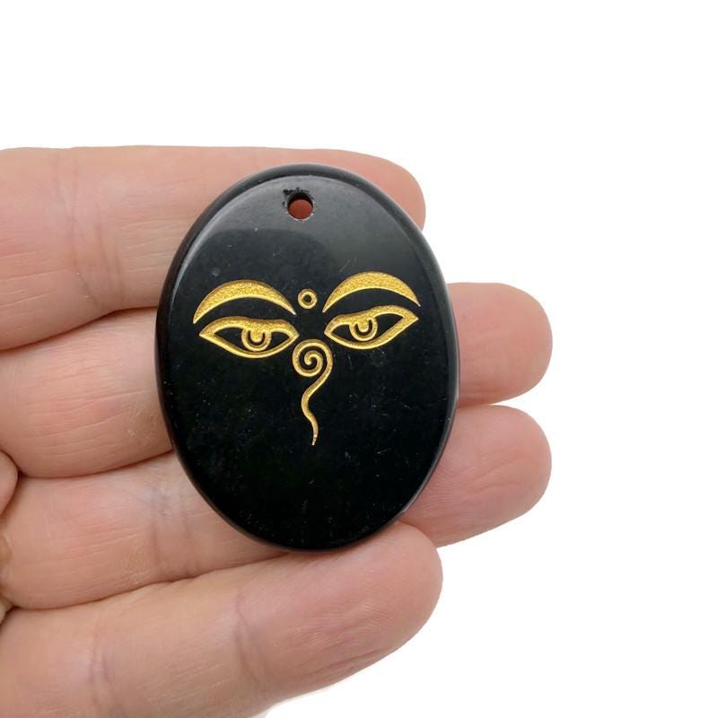 Crystal amulet with engraved Buddha eyes, drilled for spiritual insight and guidance, from GemstoneGO.