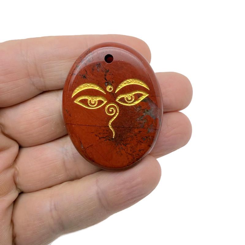 Crystal amulet engraved with Buddha eyes from GemstoneGO, featuring drilled spiritual symbols for insight and guidance.