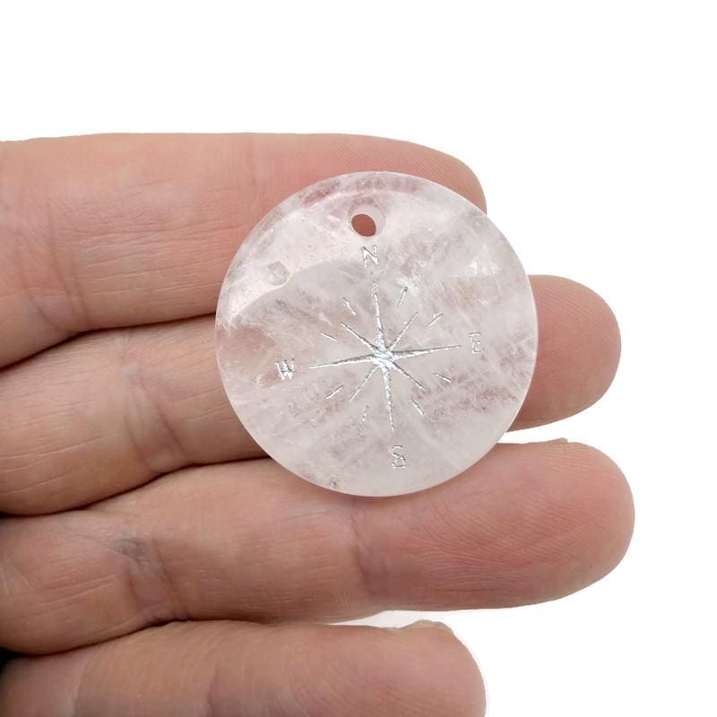 Engraved crystal compass pendant with drilled hole, designed as a traveler gift from GemstoneGO, showcasing detailed craftsmanship.