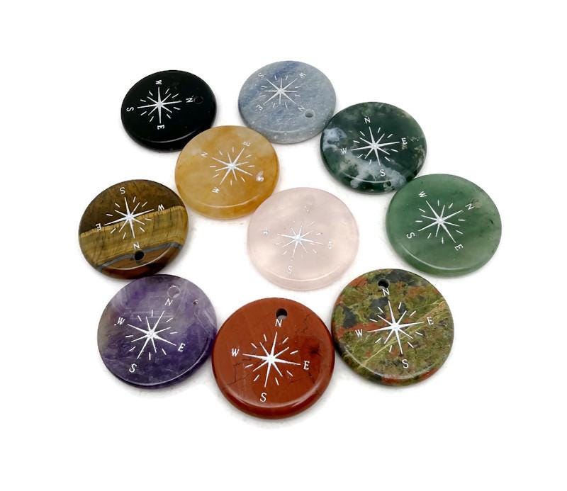 Engraved crystal compass pendant from GemstoneGO, drilled traveler gift with detailed compass design on clear crystal.
