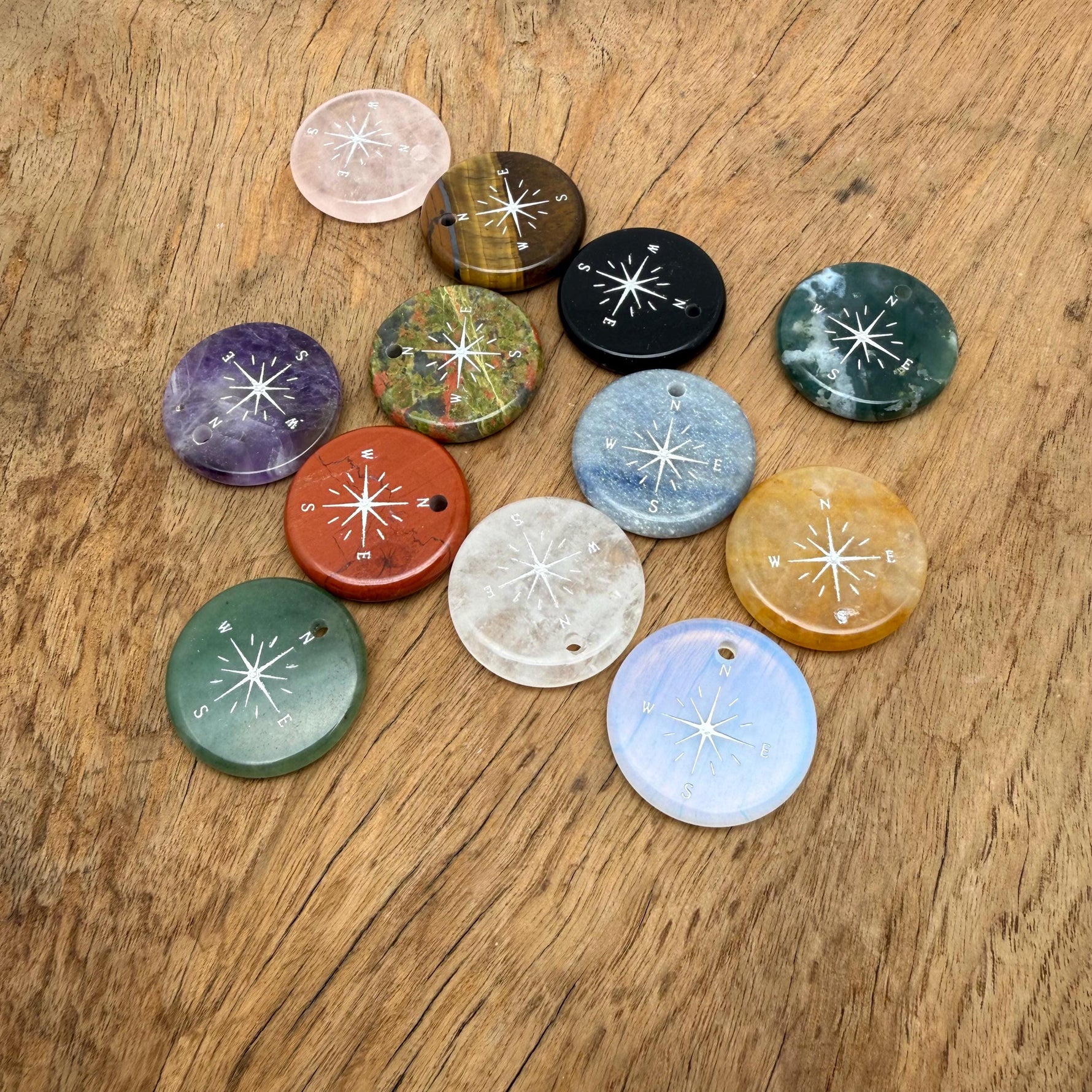 Engraved crystal compass pendant with drilled hole, featuring a detailed compass design, ideal as a traveler gift by GemstoneGO.
