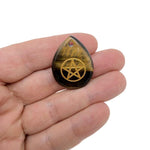 Pentagram engraved crystal from GemstoneGO, drilled for Pagan protection and balance, showcasing intricate engraving and clear crystal clarity.
