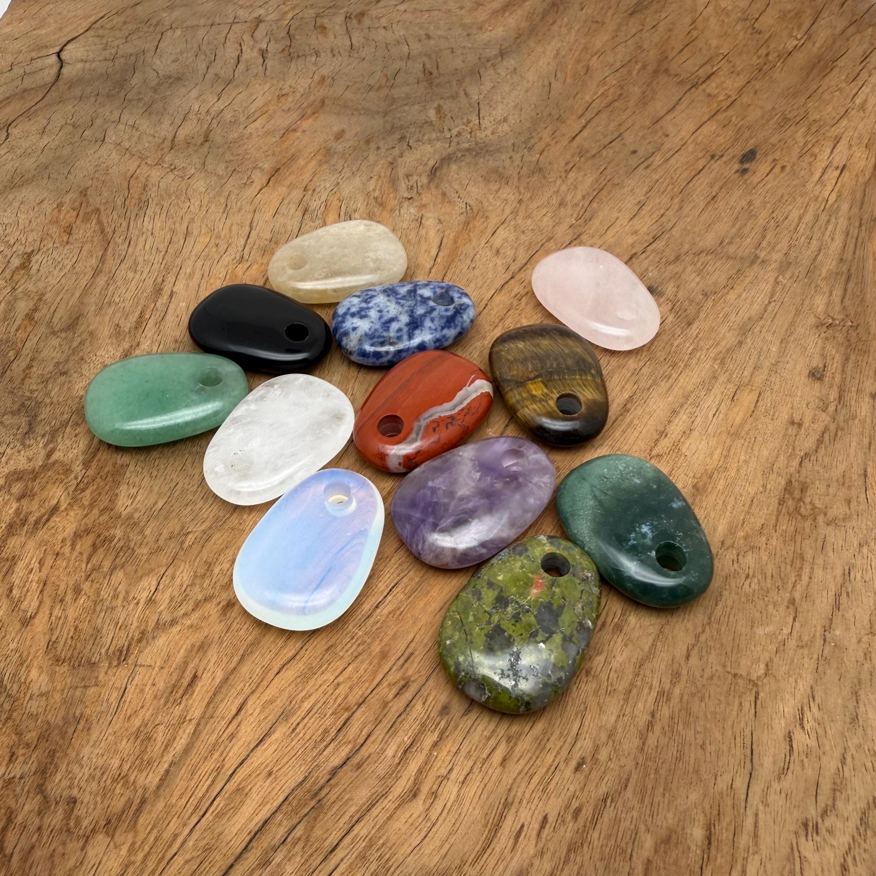 Oval crystal pendant from GemstoneGO, natural stone jewelry making bead with a smooth, polished surface in a mixed color palette.