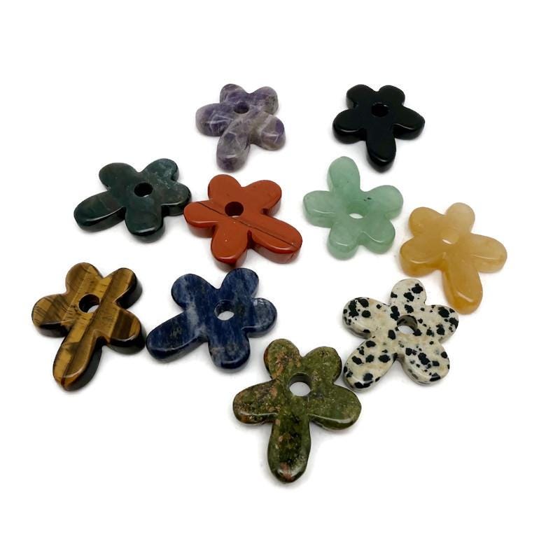 Carved crystal flower gemstone pendant with colorful gemstone accents, featuring a detailed floral design on a silver chain.