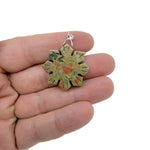 Snowflake gemstone pendant featuring a healing stone design from GemstoneGO, showcasing a delicate silver setting with a clear gemstone.