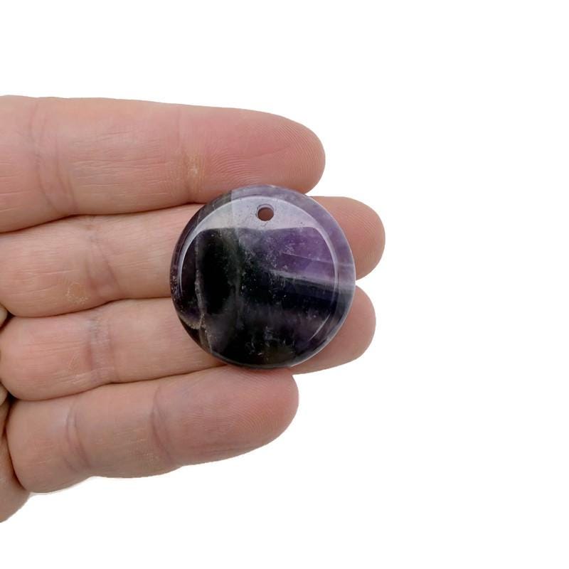 Round gemstone pendant featuring a drilled natural crystal disc charm from GemstoneGO, showcasing vibrant crystal colors and polished surface.