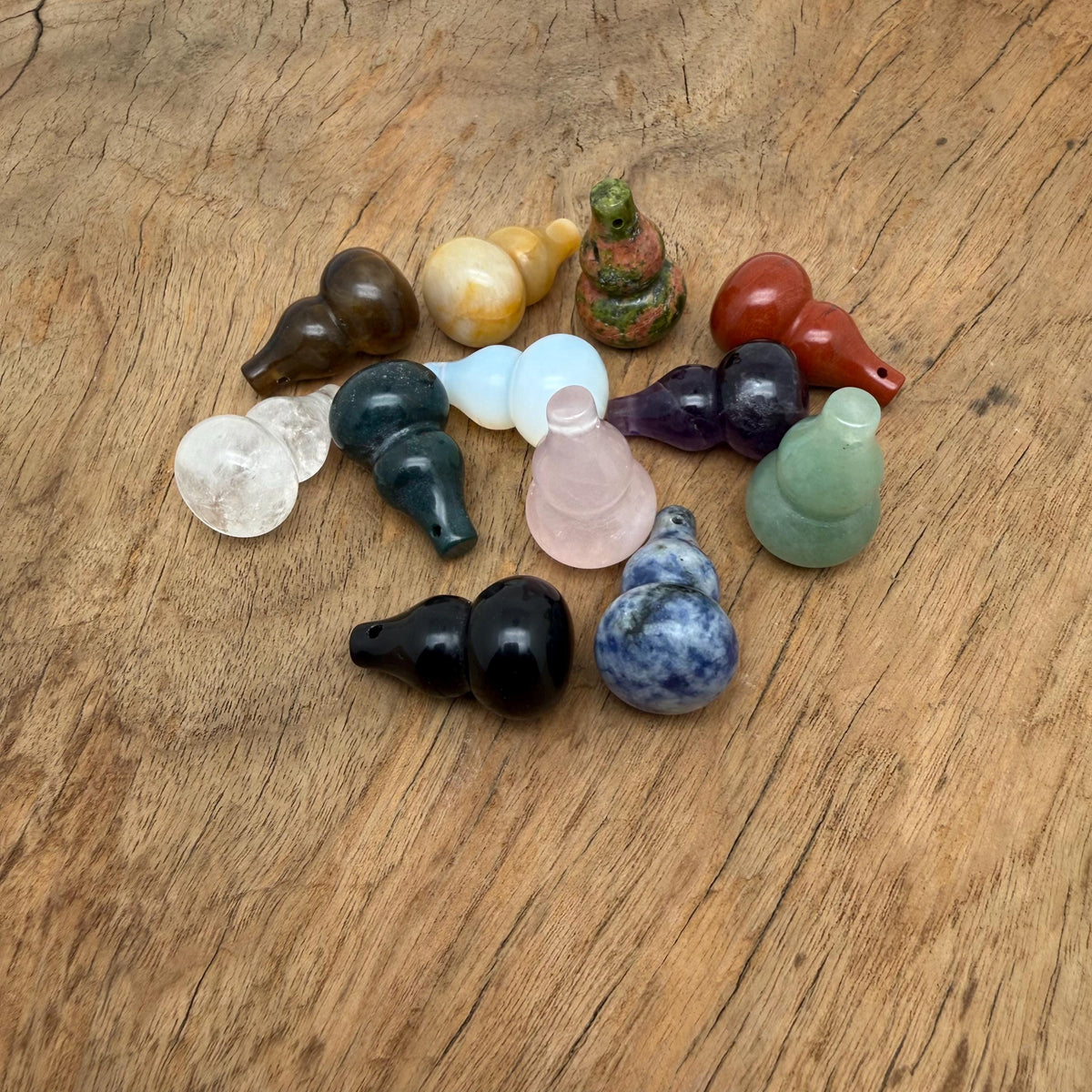 Wu Lou crystal pendant featuring a gemstone gourd design, showcased by GemstoneGO in a natural setting with vibrant colors.