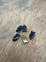 Tiger Eye fish-shaped crystal pendant with a polished fish charm, showcasing warm golden-brown hues and detailed craftsmanship.
