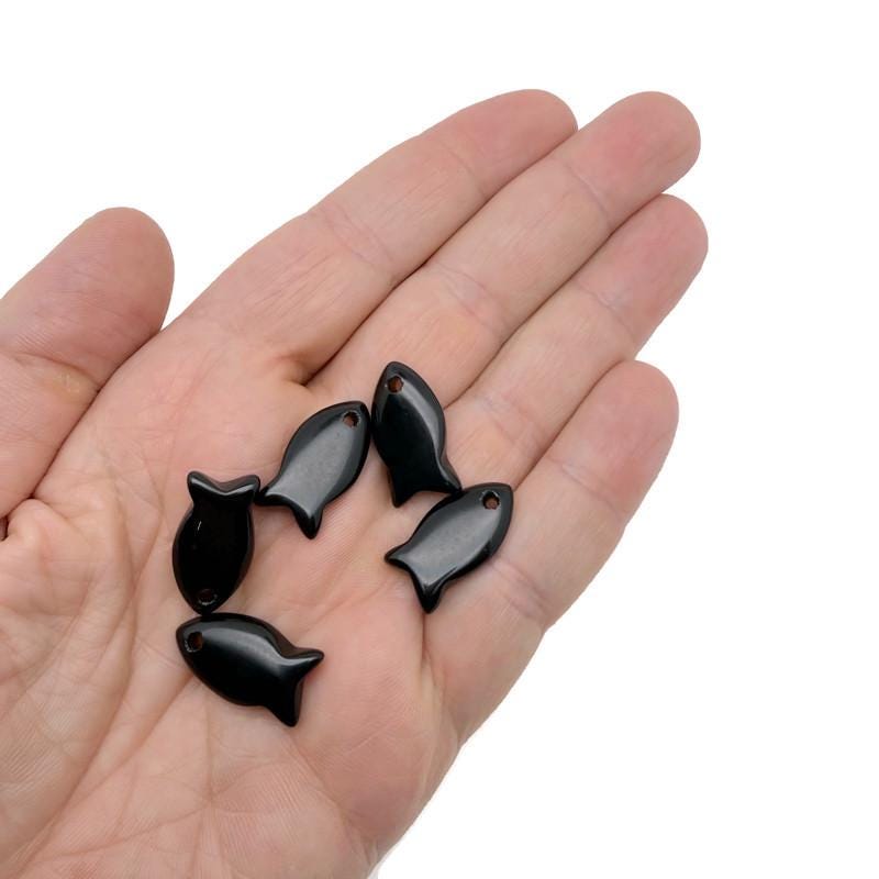Obsidian fish-shaped crystal pendant with a healing stone fish charm, featuring a polished black gemstone and silver-tone bail.