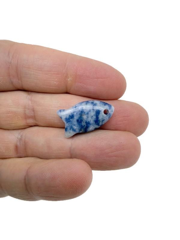 Sodalite fish-shaped crystal pendant with silver bail, showcasing a blue and white stone charm for jewelry and healing purposes.