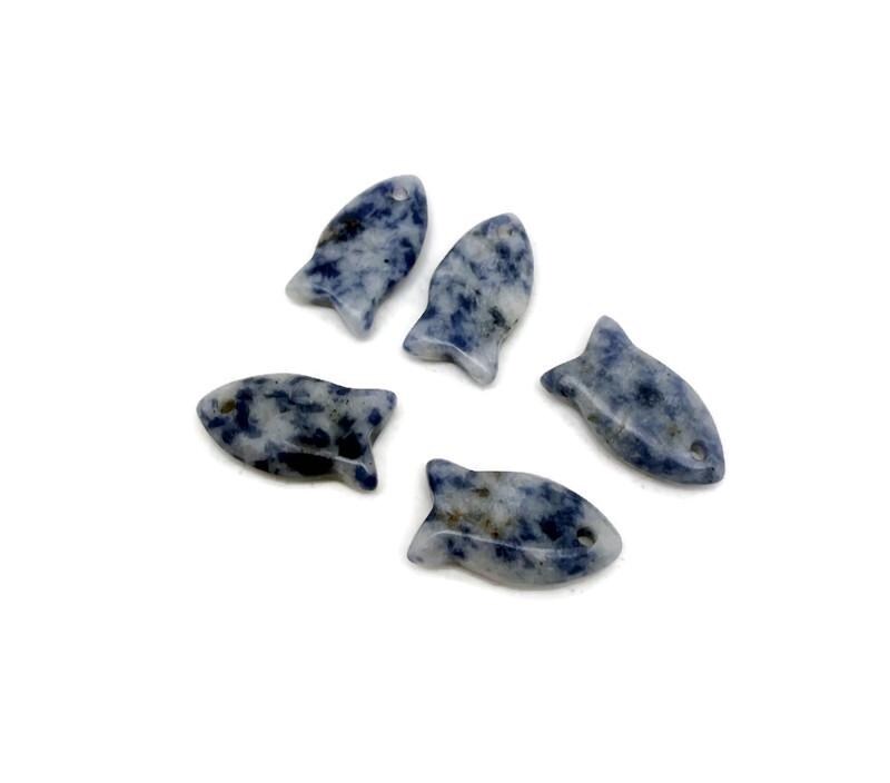 Sodalite fish-shaped crystal pendant with a healing stone charm, featuring a vibrant blue and white gemstone design.