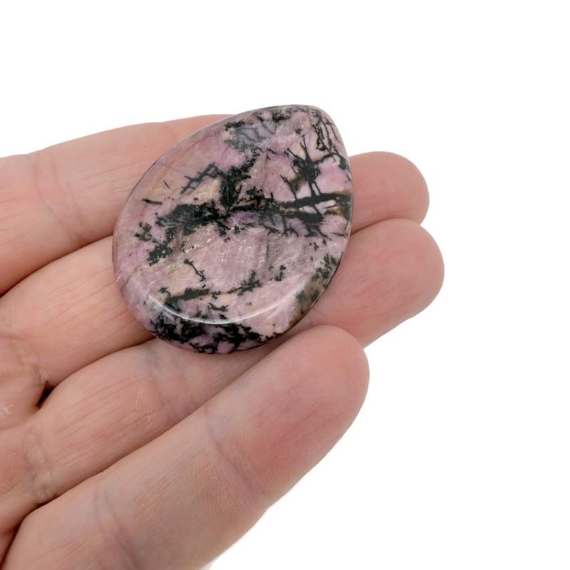 Rhodonite worry stone from GemstoneGO, 45mm soothing crystal with polished pink and black veined surface for stress relief.