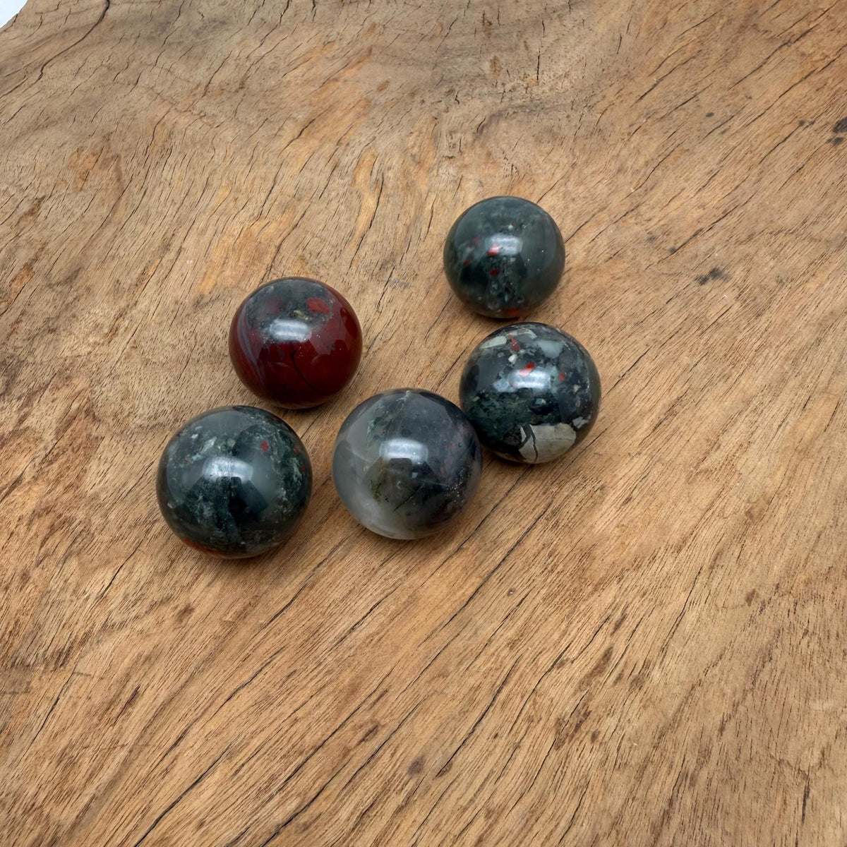 African Bloodstone sphere, 25mm crystal ball by GemstoneGO, showcasing deep green stone with red bloodstone inclusions.