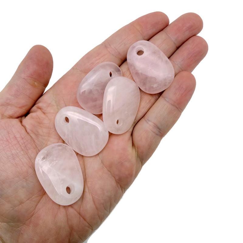 Rose quartz oval crystal pendant from GemstoneGO featuring a smooth, natural stone jewelry-making bead with a polished finish.