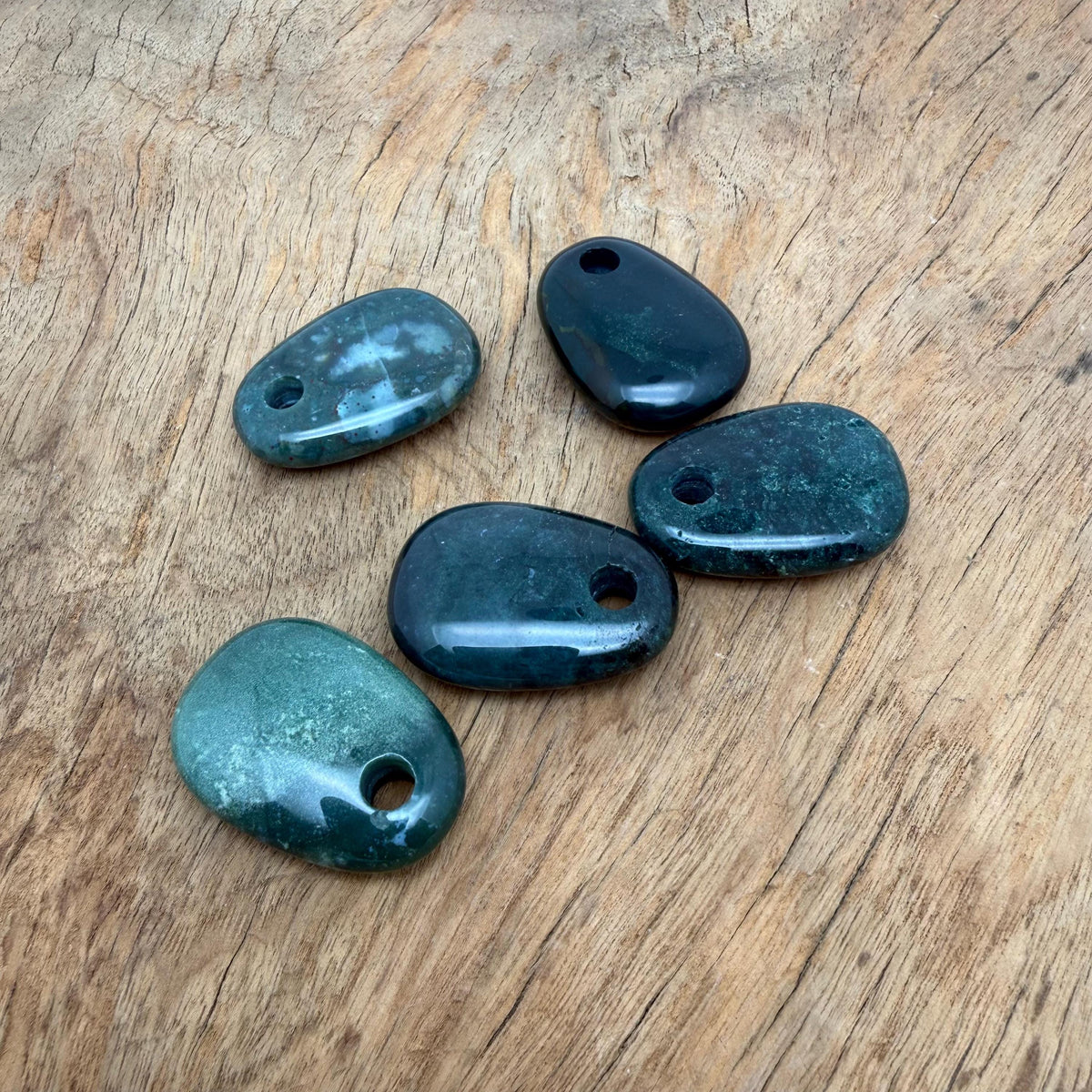Moss Agate oval crystal pendant from GemstoneGO, showcasing a natural stone bead with earthy green and brown patterns for jewelry making