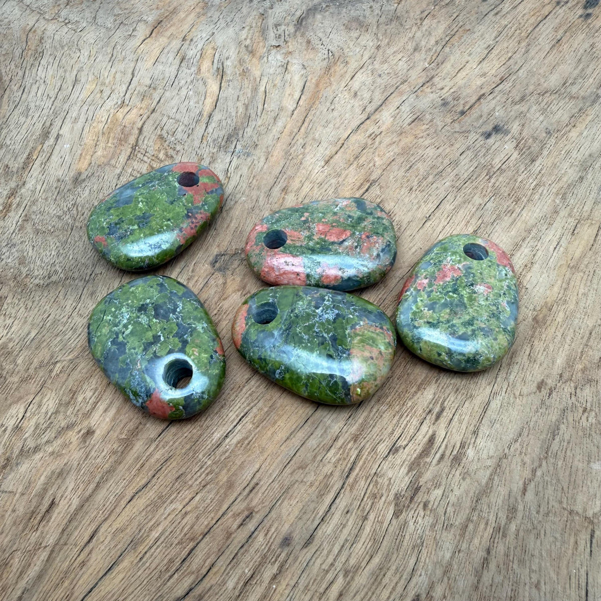 Unakite oval crystal pendant from GemstoneGO featuring natural stone jewelry making bead on a silver chain.