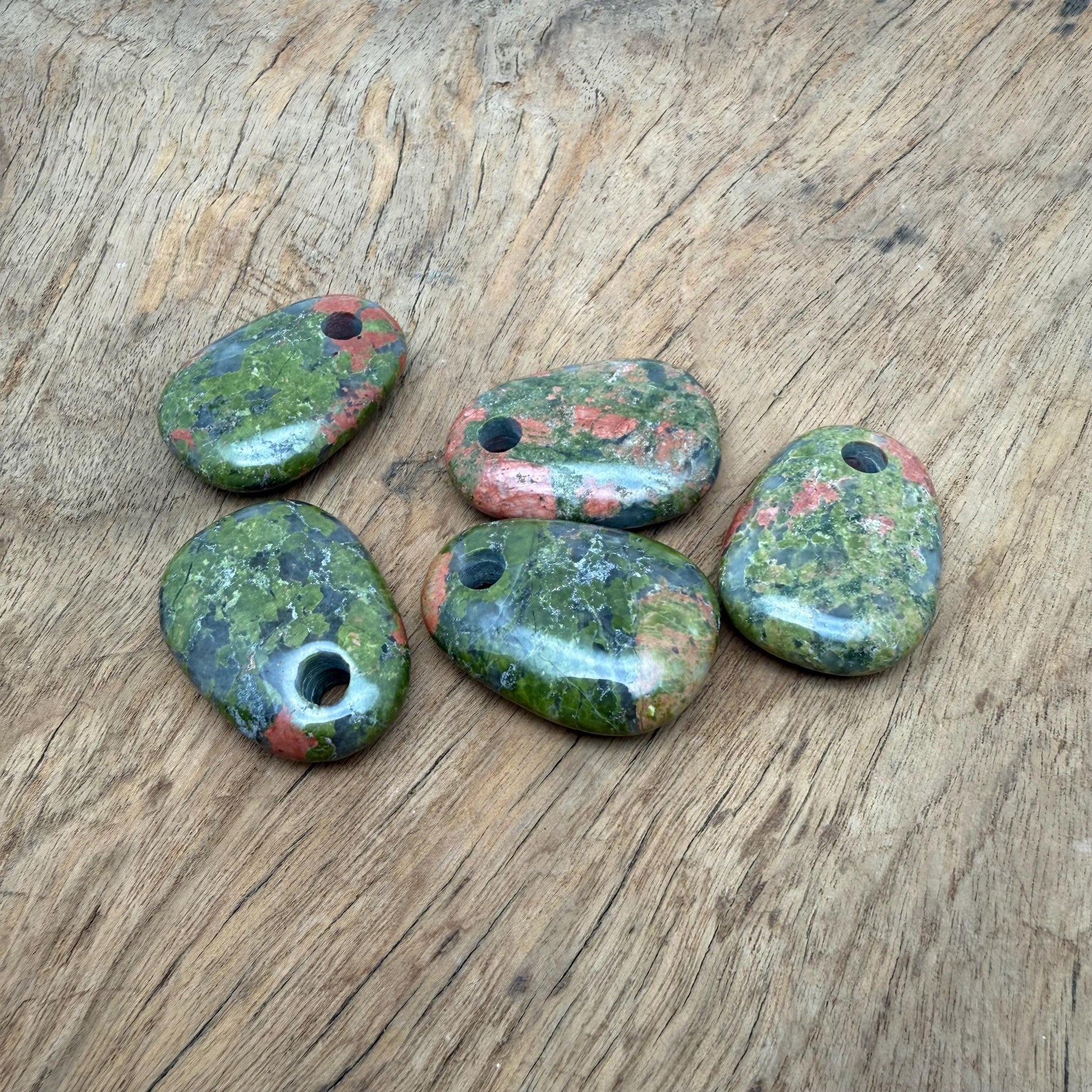 Unakite oval crystal pendant from GemstoneGO featuring natural stone jewelry making bead on a silver chain.